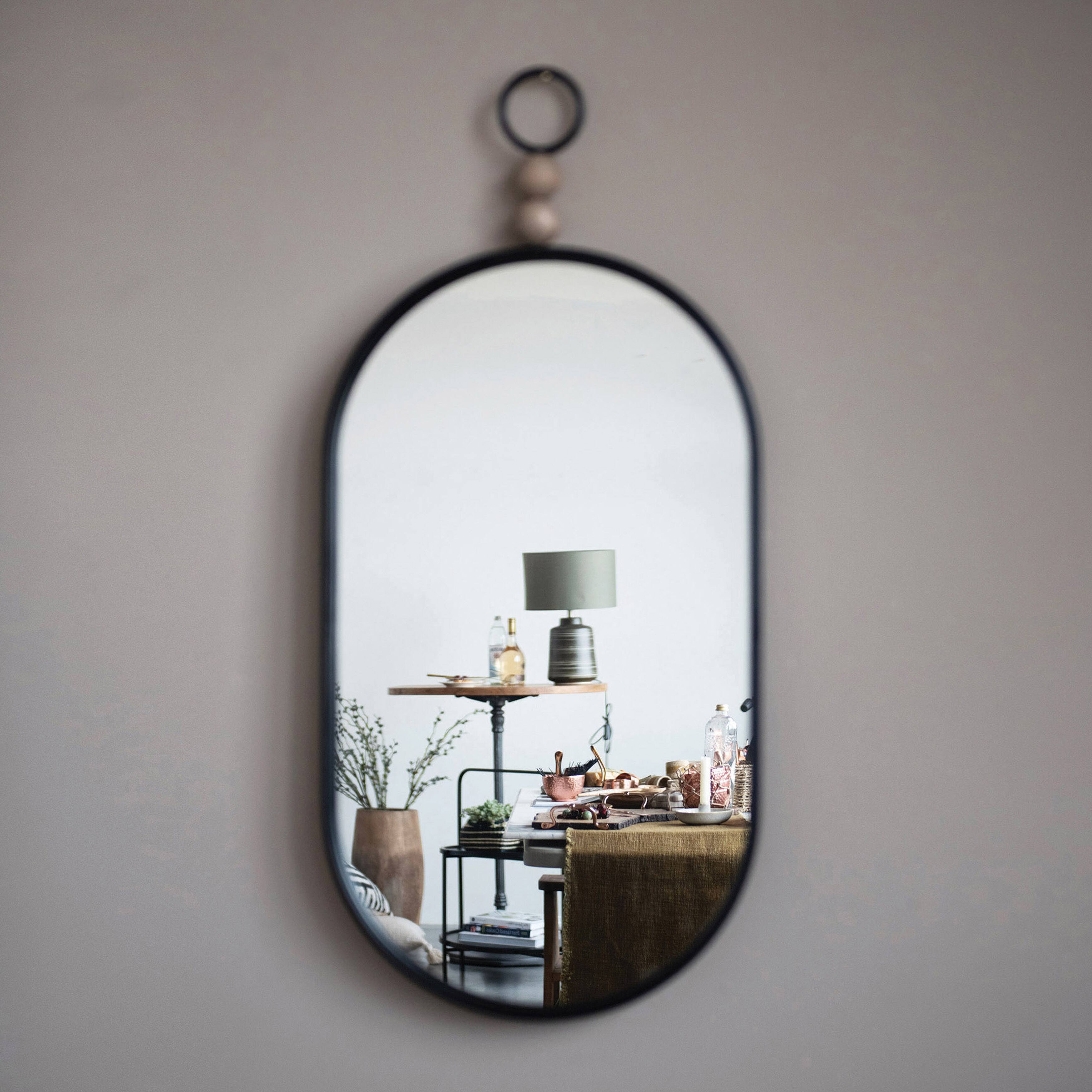 Hello Honey&#xAE; Black Oval Metal Wall Mirror with Wood Beads
