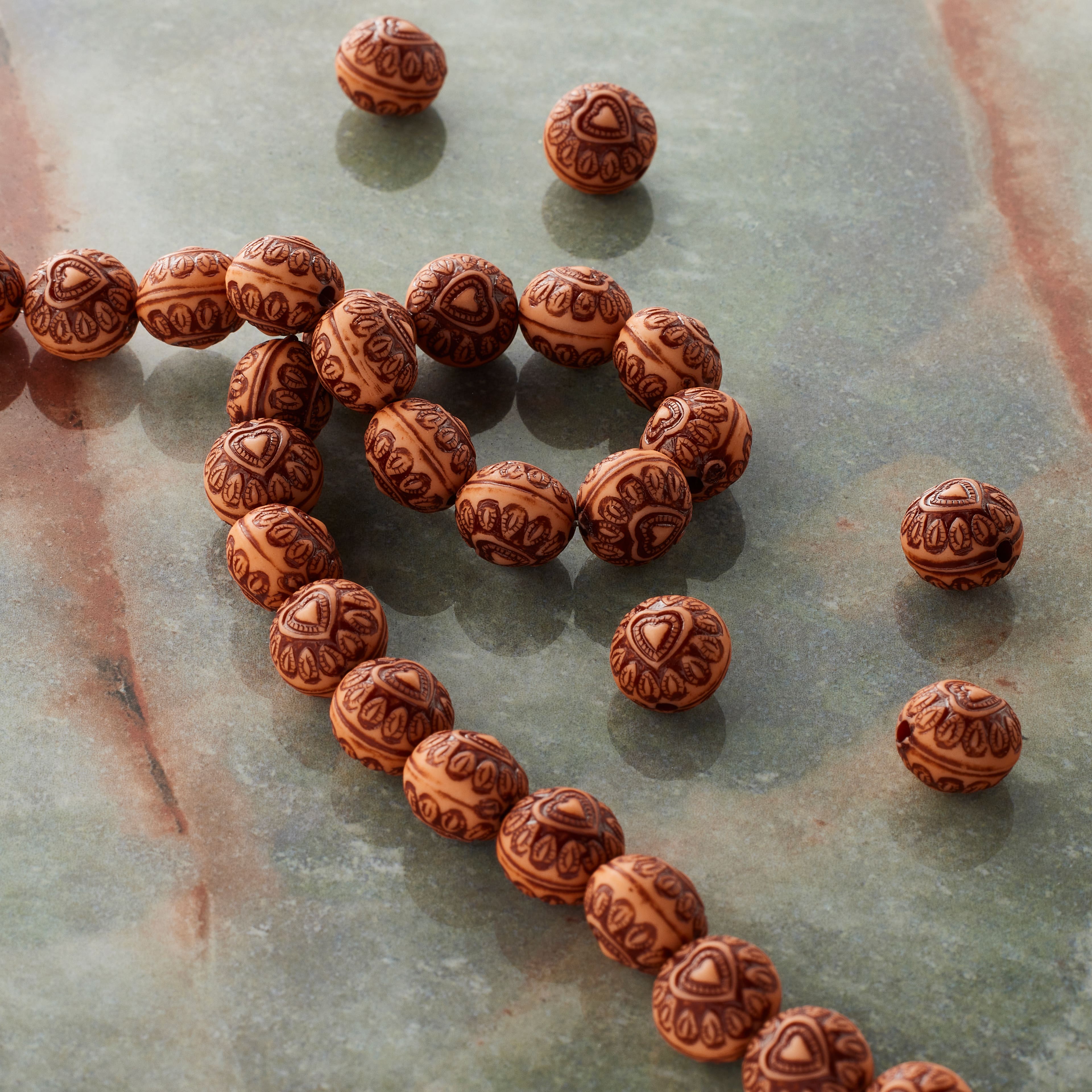 12 Packs: 32 ct. (384 total)  Amber Heart Design Resin Round Beads, 10mm by Bead Landing&#x2122;