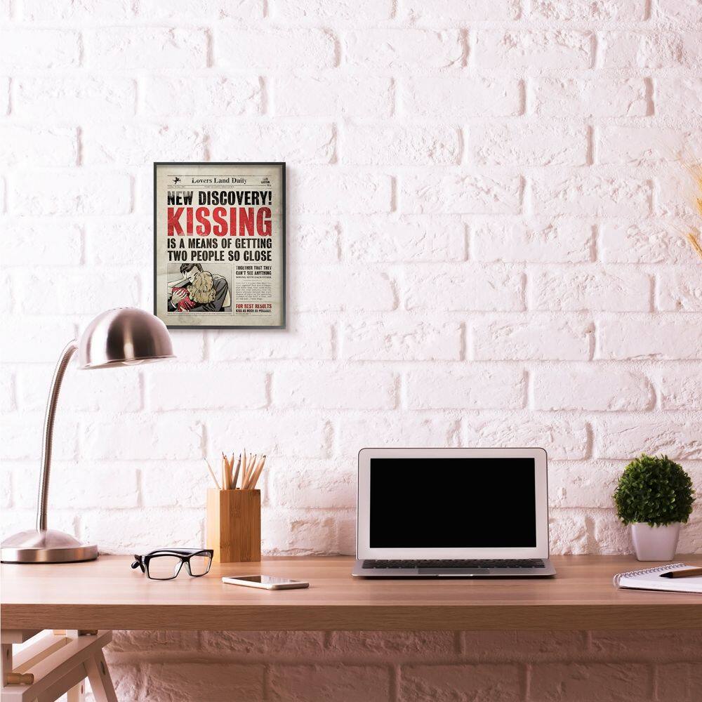 Stupell Industries Kissing Newspaper Wall Art in Black Frame