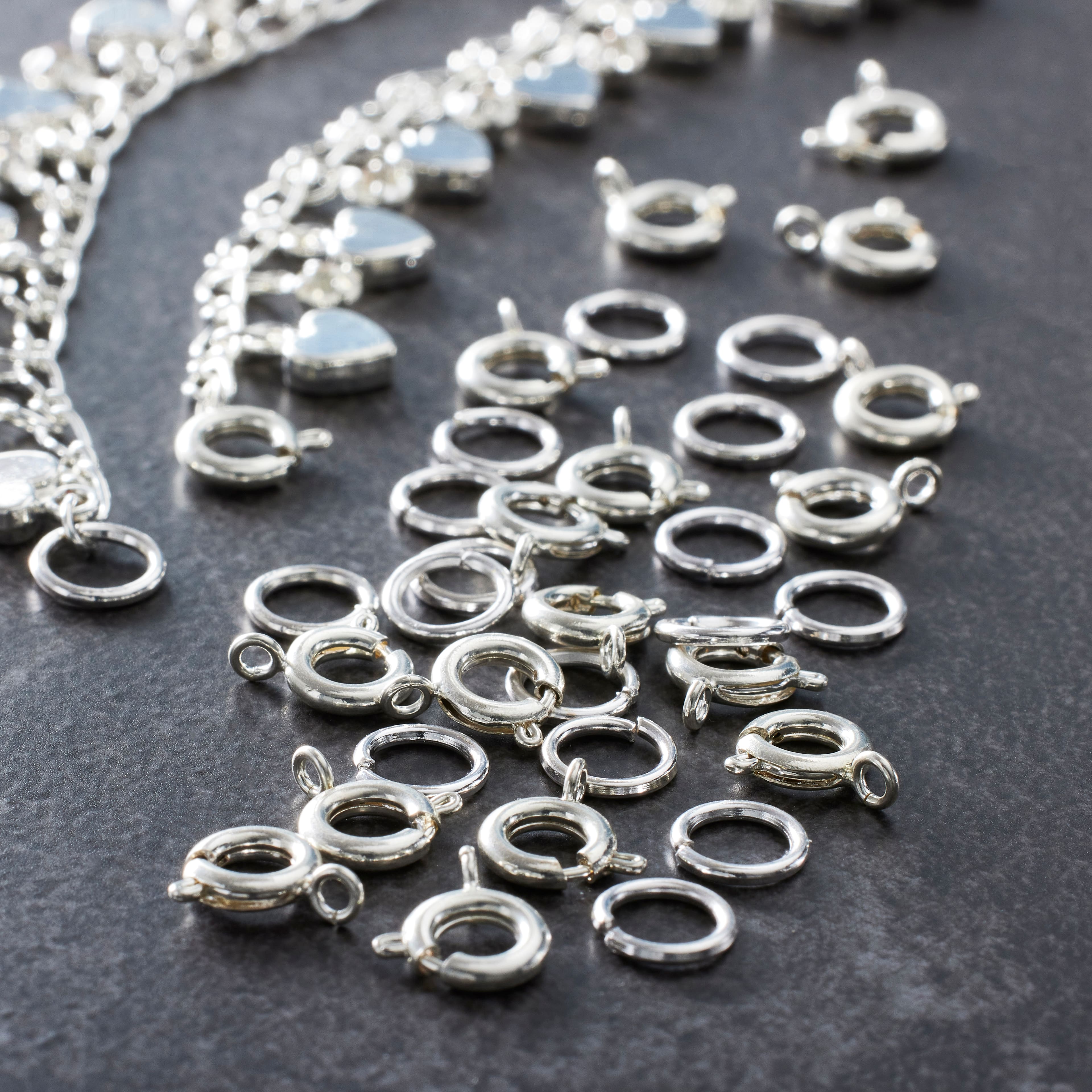 12 Packs: 36 ct. (432 total) 7mm Silver Spring Ring Clasps by Bead Landing&#x2122;