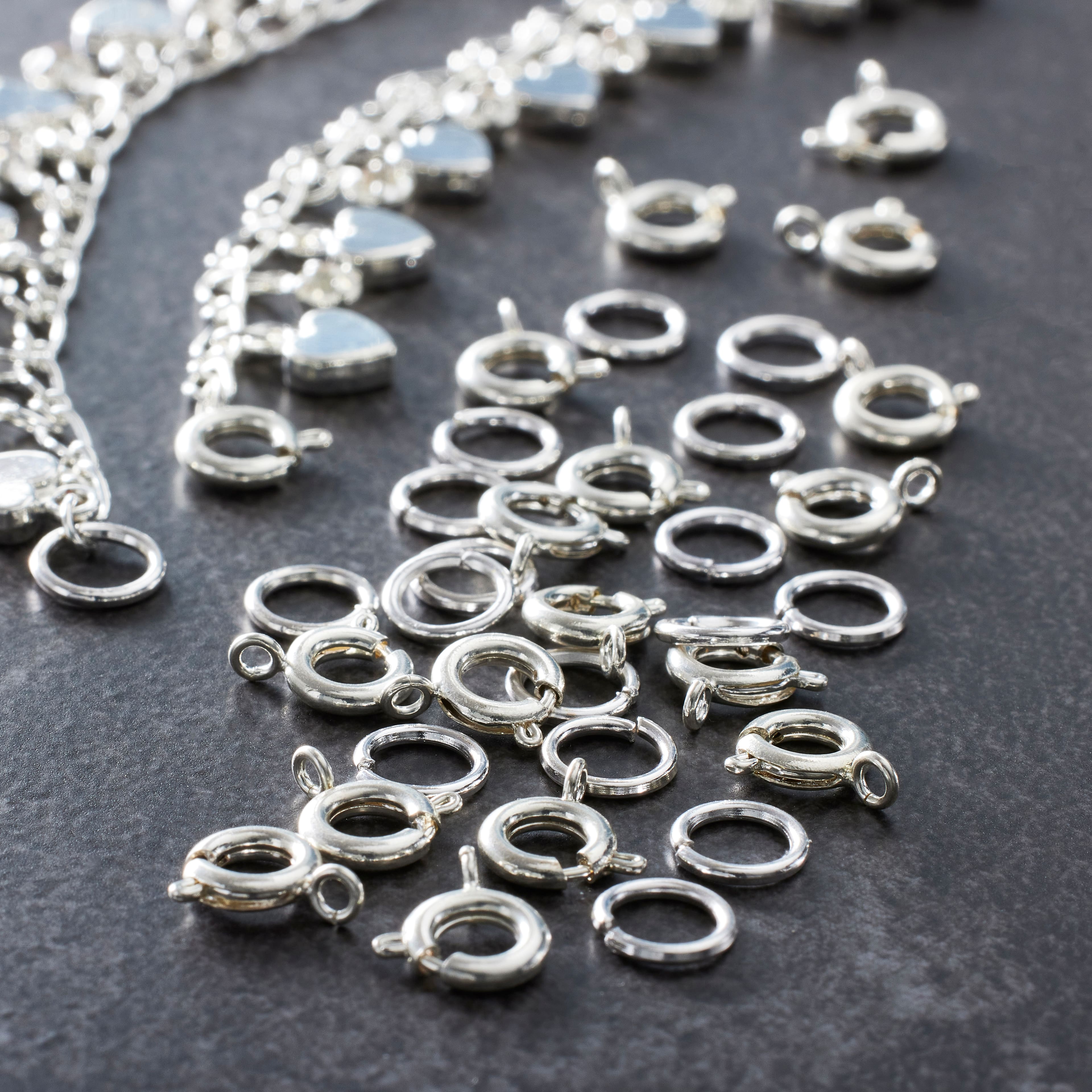 12 Packs: 36 ct. (432 total) 7mm Silver Spring Ring Clasps by Bead Landing™
