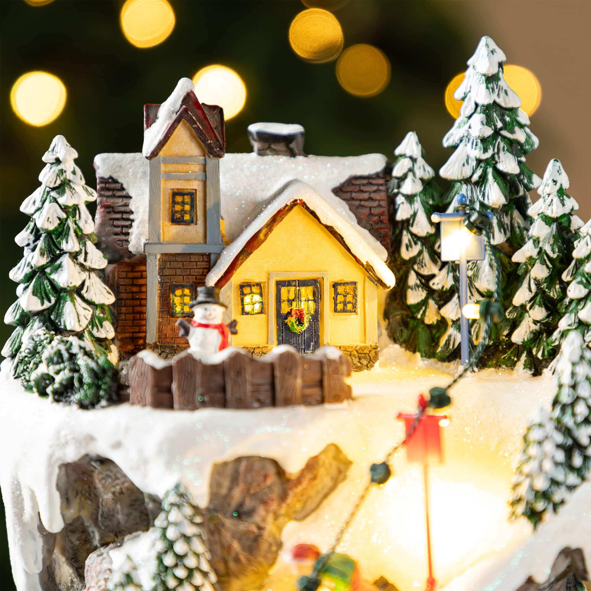 Glitzhome&#xAE; 15.5&#x22; Lighted Christmas Skiing Moutain Resin Village with Movement and Music
