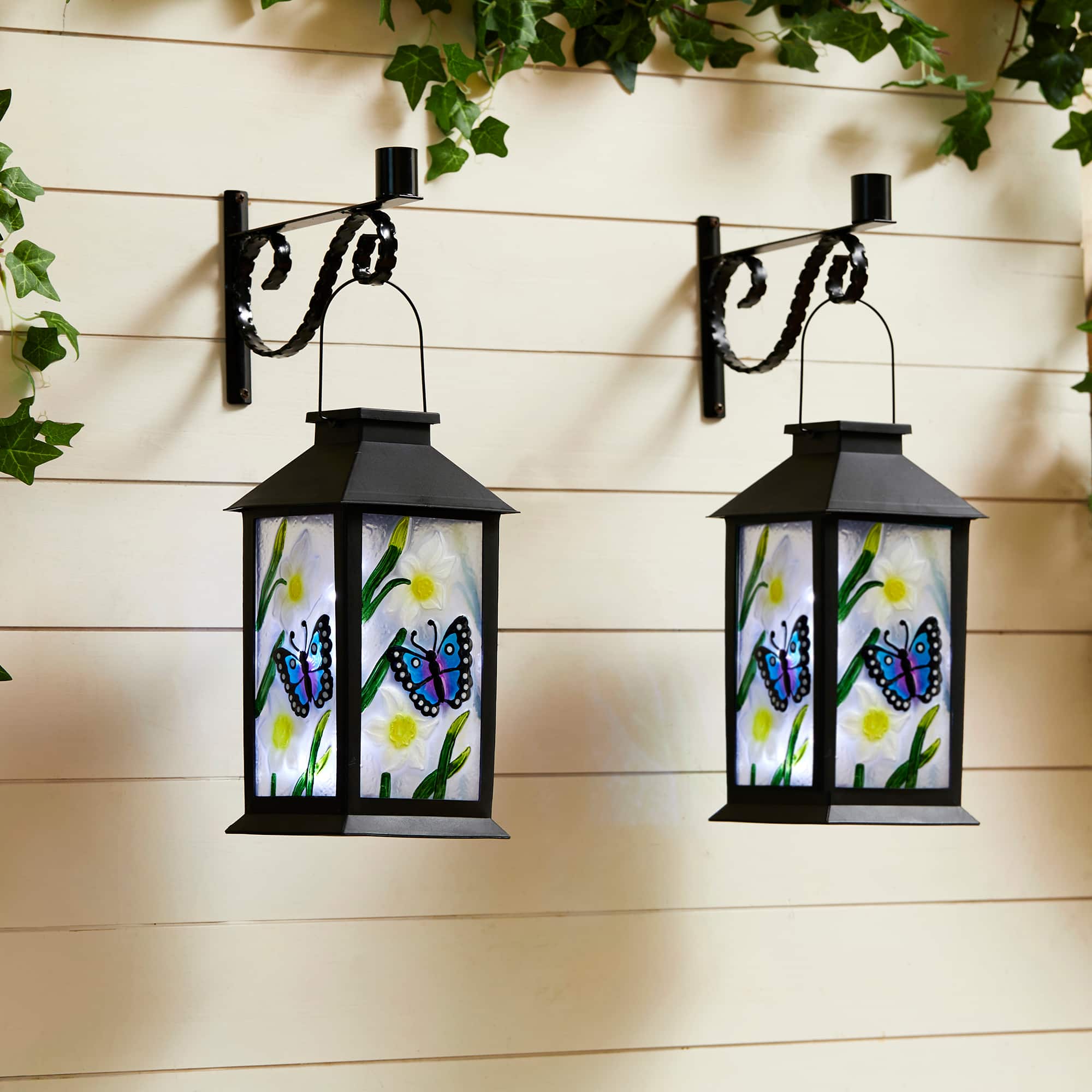 Glitzhome&#xAE; 11&#x22; Glass with Butterfly &#x26; Flower Pattern Solar Powered Hanging Lanterns, 2ct.