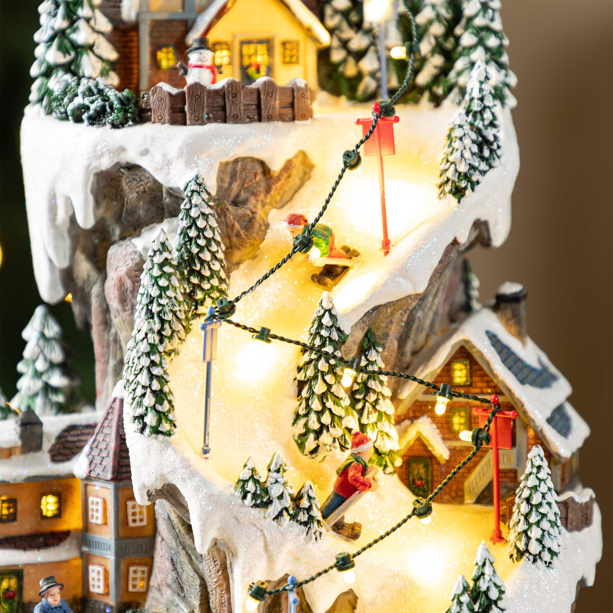 Glitzhome&#xAE; 15.5&#x22; Lighted Christmas Skiing Moutain Resin Village with Movement and Music