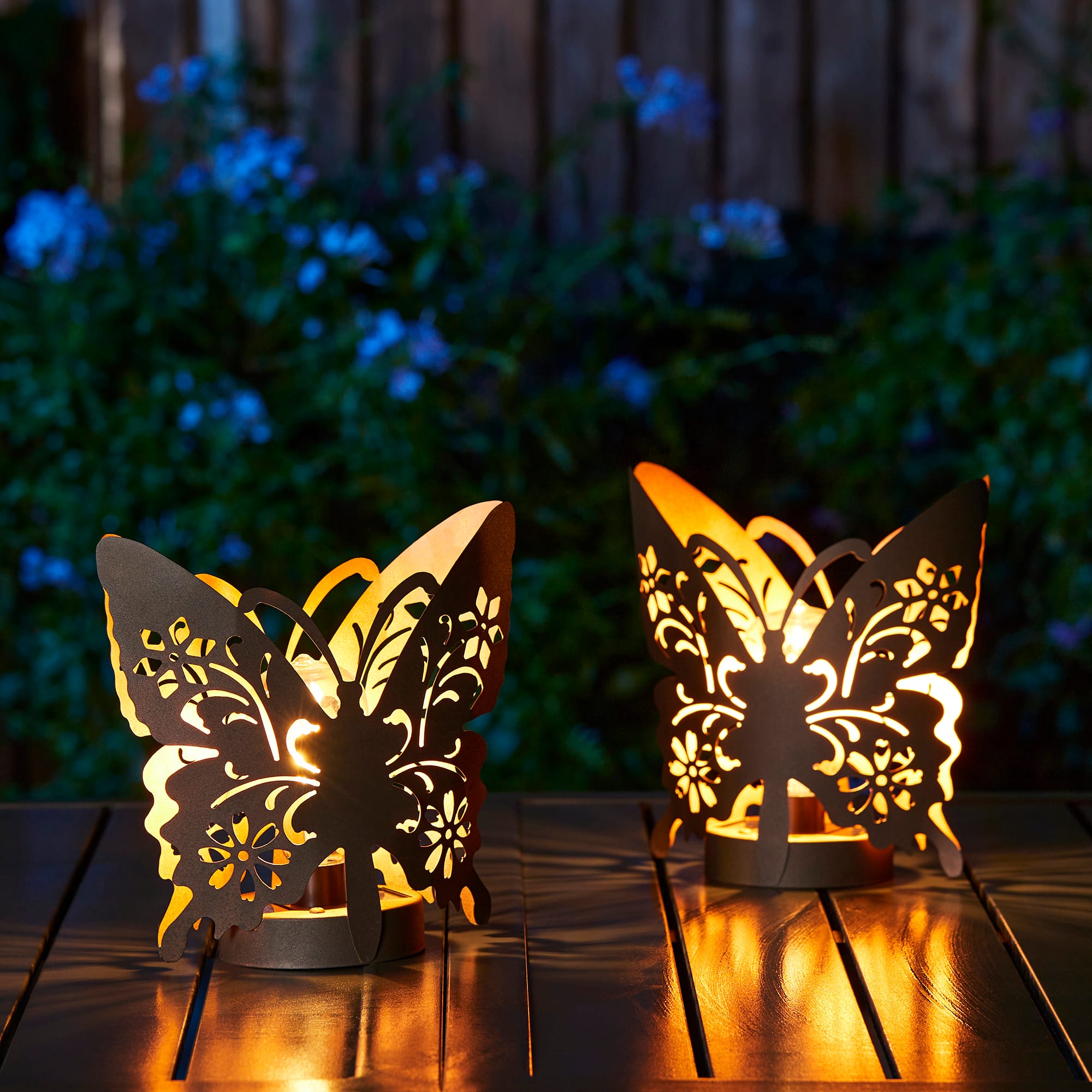 Glitzhome&#xAE; 9&#x22; Metal Flying Butterfly Silhouette Solar Powdered Edison Bulb Outdoor Lanterns, 2ct.