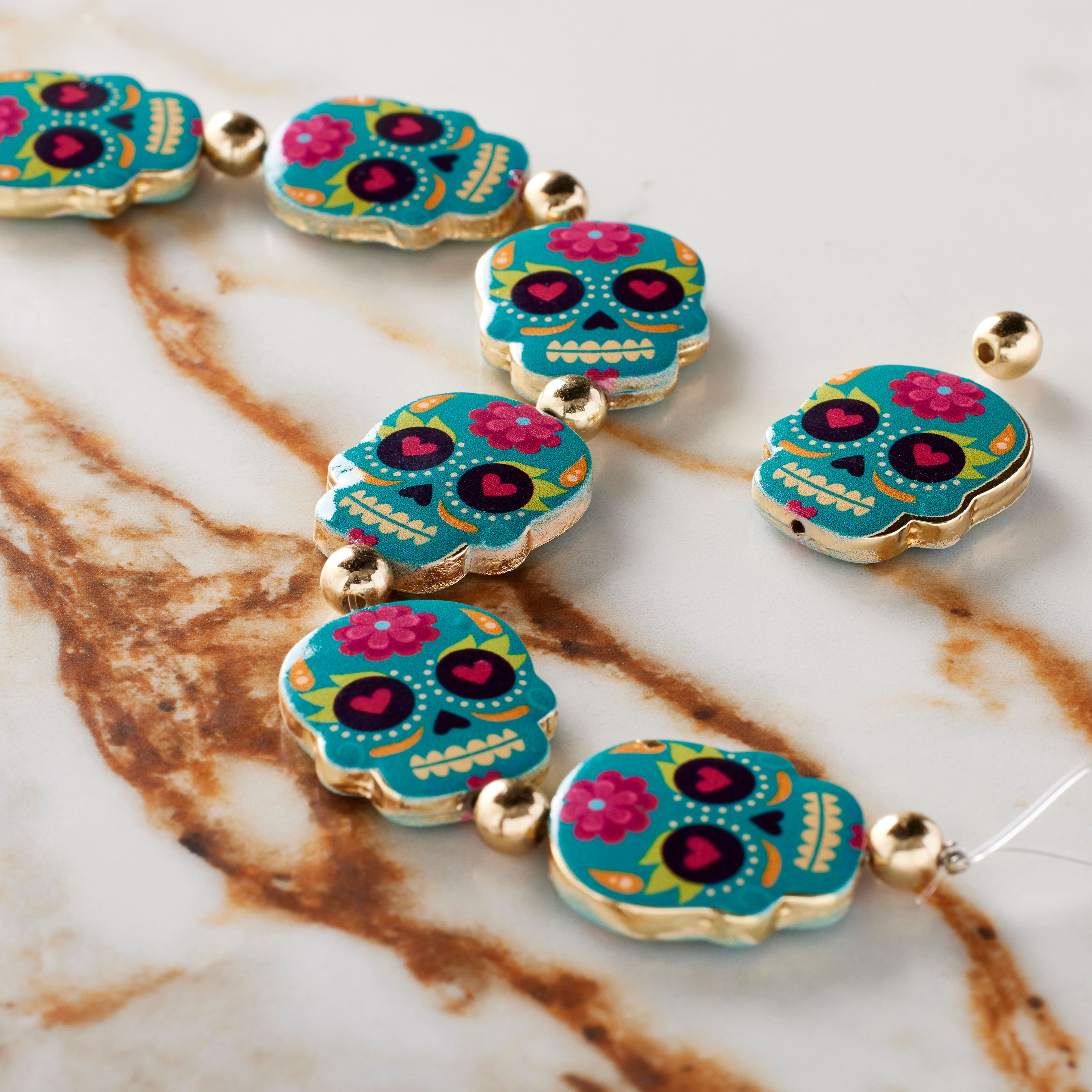 12 Packs: 7 ct. (84 total) Blue Enamel Metal Sugar Skull Beads, 20mm by Bead Landing™