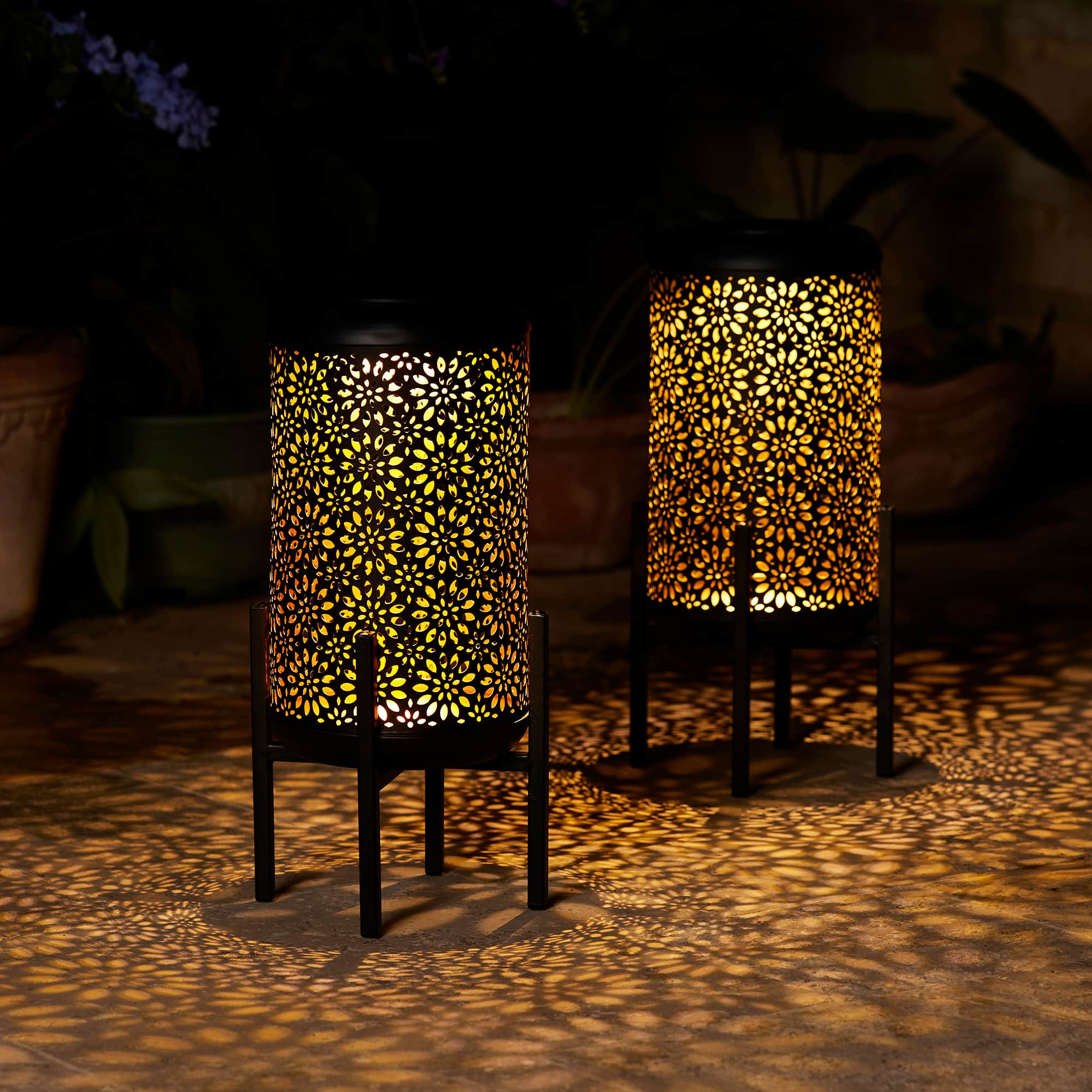 Glitzhome&#xAE; 14.25&#x22; Black Metal Cutout Flower Pattern Solar Powered LED Outdoor Lanterns, 2ct.