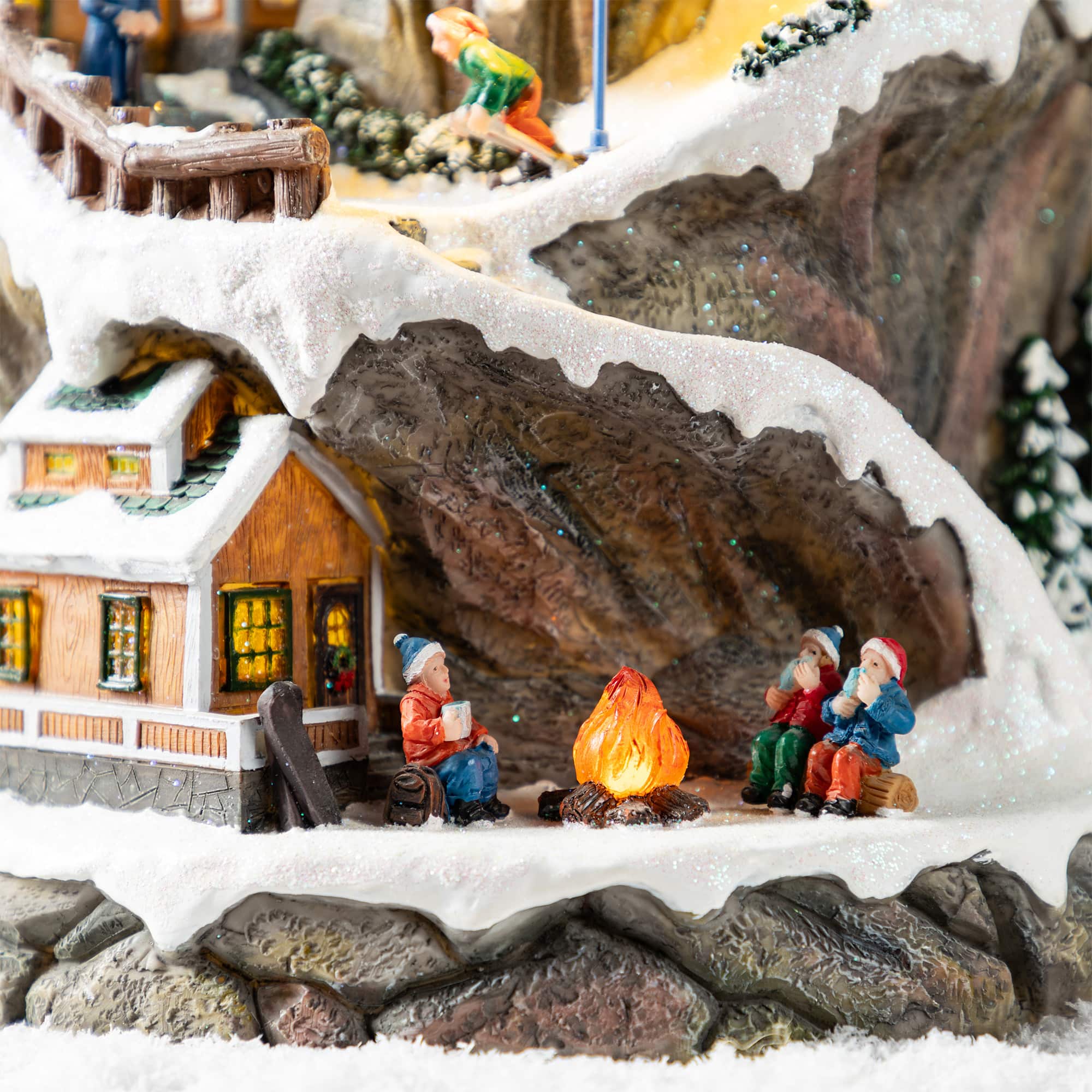 Glitzhome&#xAE; 15.5&#x22; Lighted Christmas Skiing Moutain Resin Village with Movement and Music
