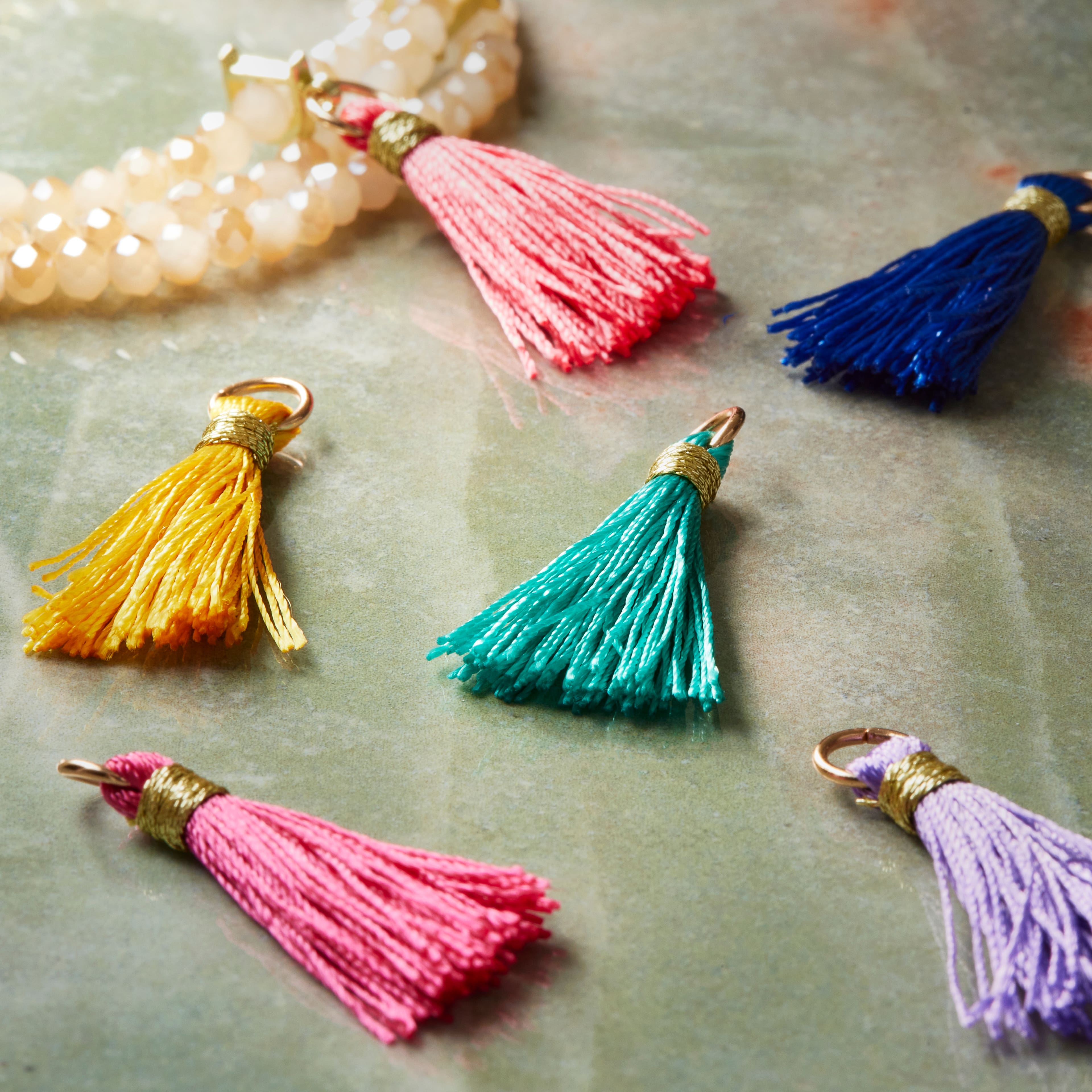 12 Packs: 12 ct. (144 total) Charmalong&#x2122; Tassel Charms by Bead Landing&#x2122;