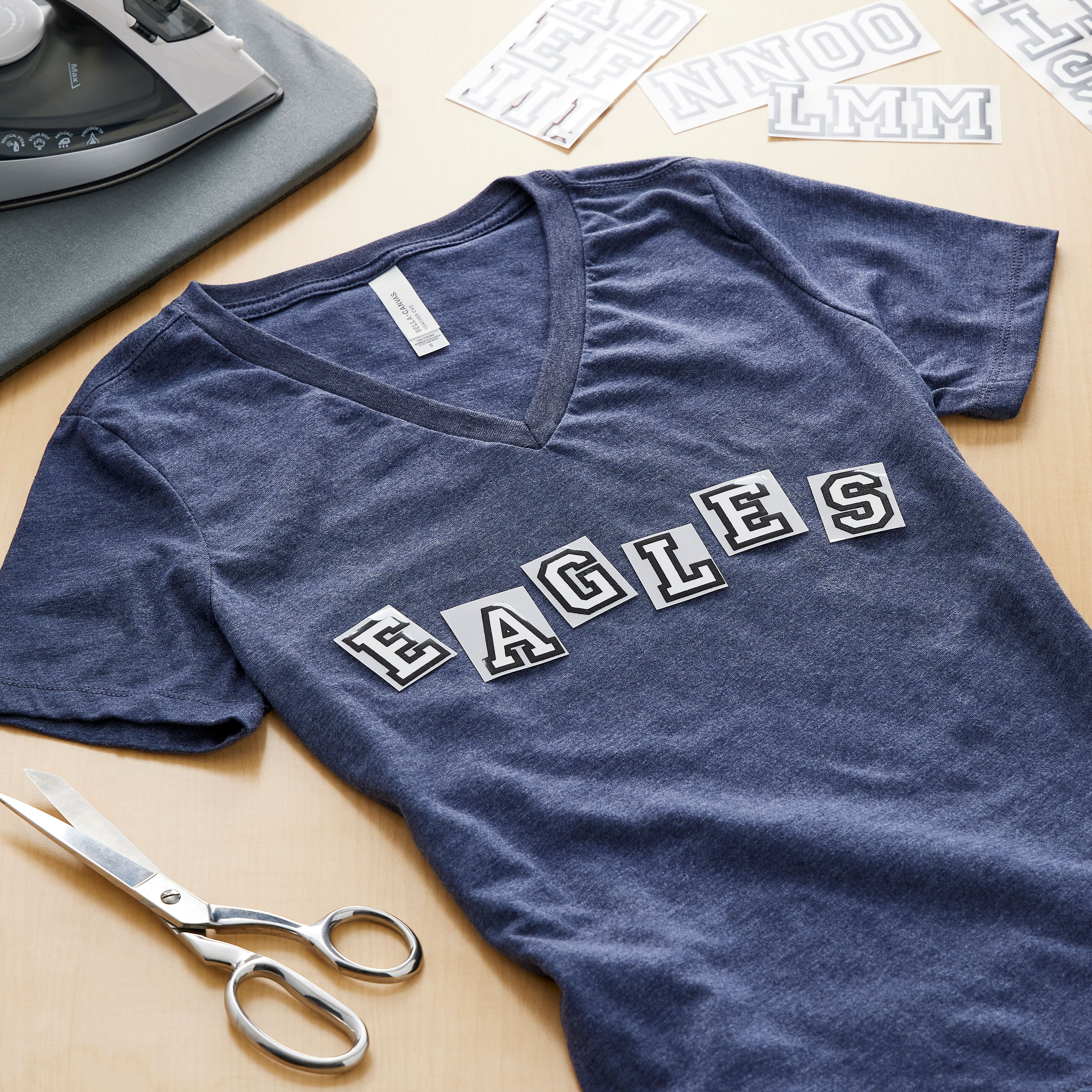 12 Packs: 49 ct. (588 total) 1.5" Iron-On White with Black Outline Athletic Letters by Make Market®