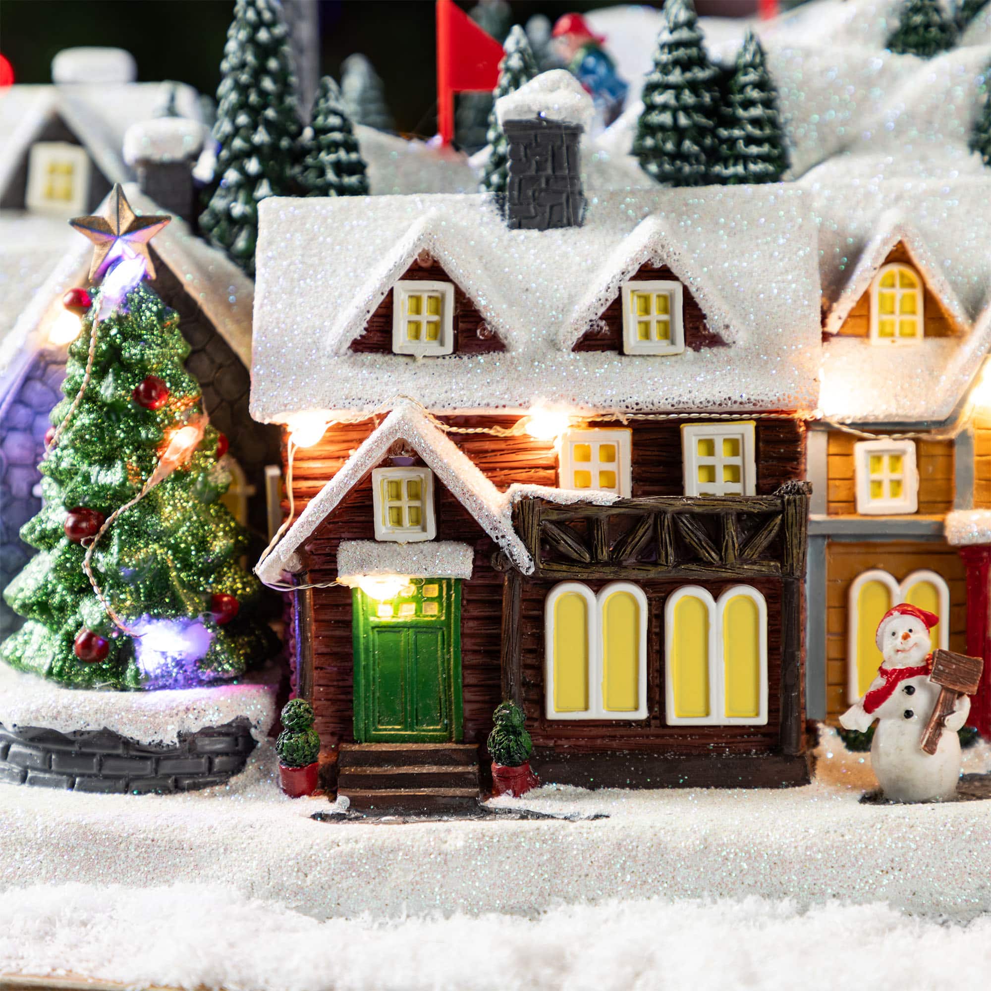 Glitzhome&#xAE; 16&#x22; Christmas Oversized Resin Lighted Musical Skiing Table Village Decor