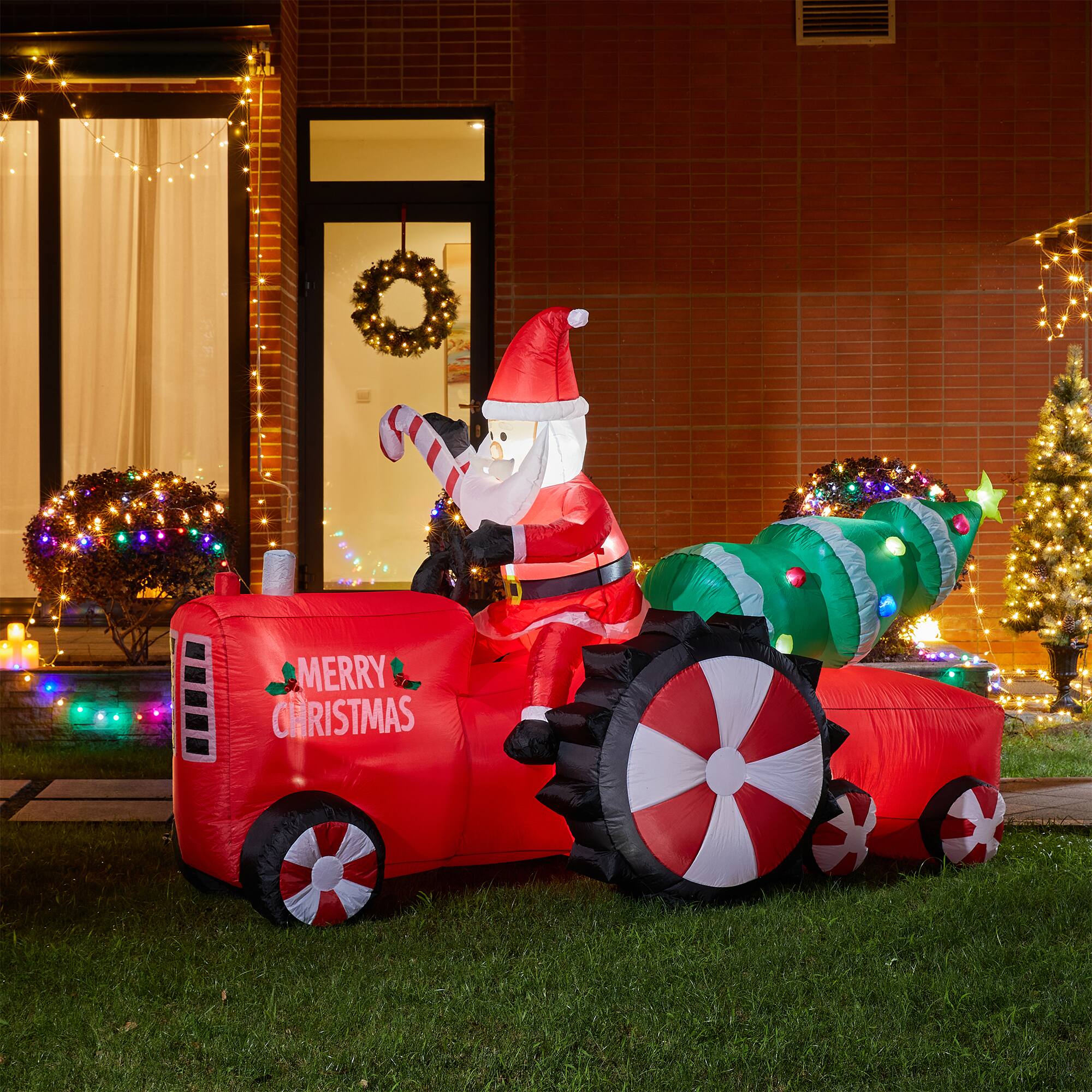 Glitzhome® 11ft. Lighted Inflatable Santa on Tractor Décor