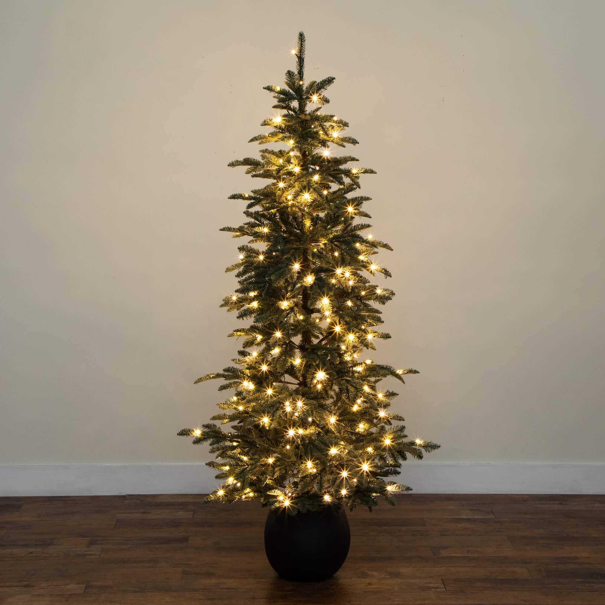 6ft. Pre-Lit Pine Artificial Christmas Tree in Black Decorative Planter with Warm White LED Lights