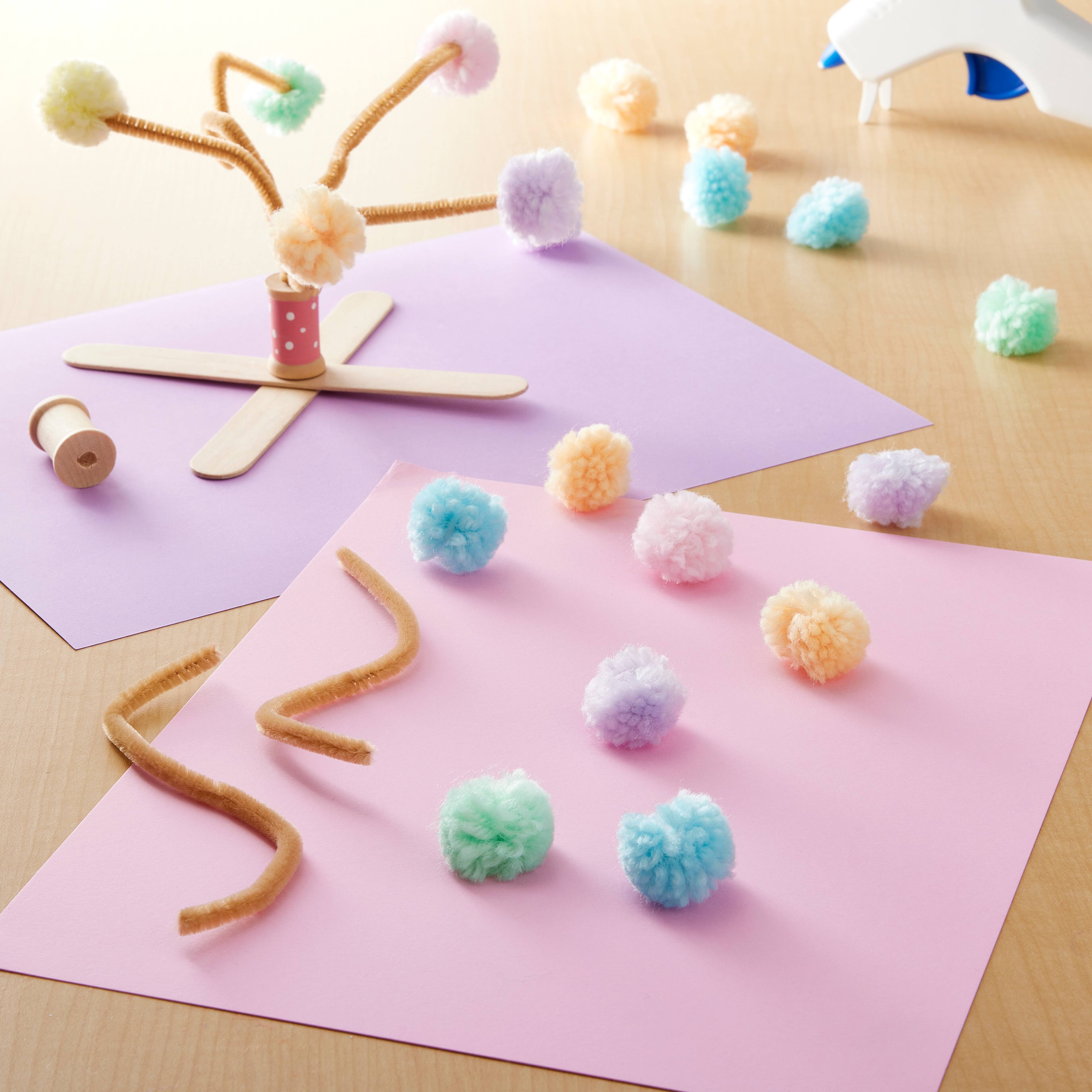 12 Packs: 60 ct. (720 total) Pastel Yarn Pom Poms by Creatology™