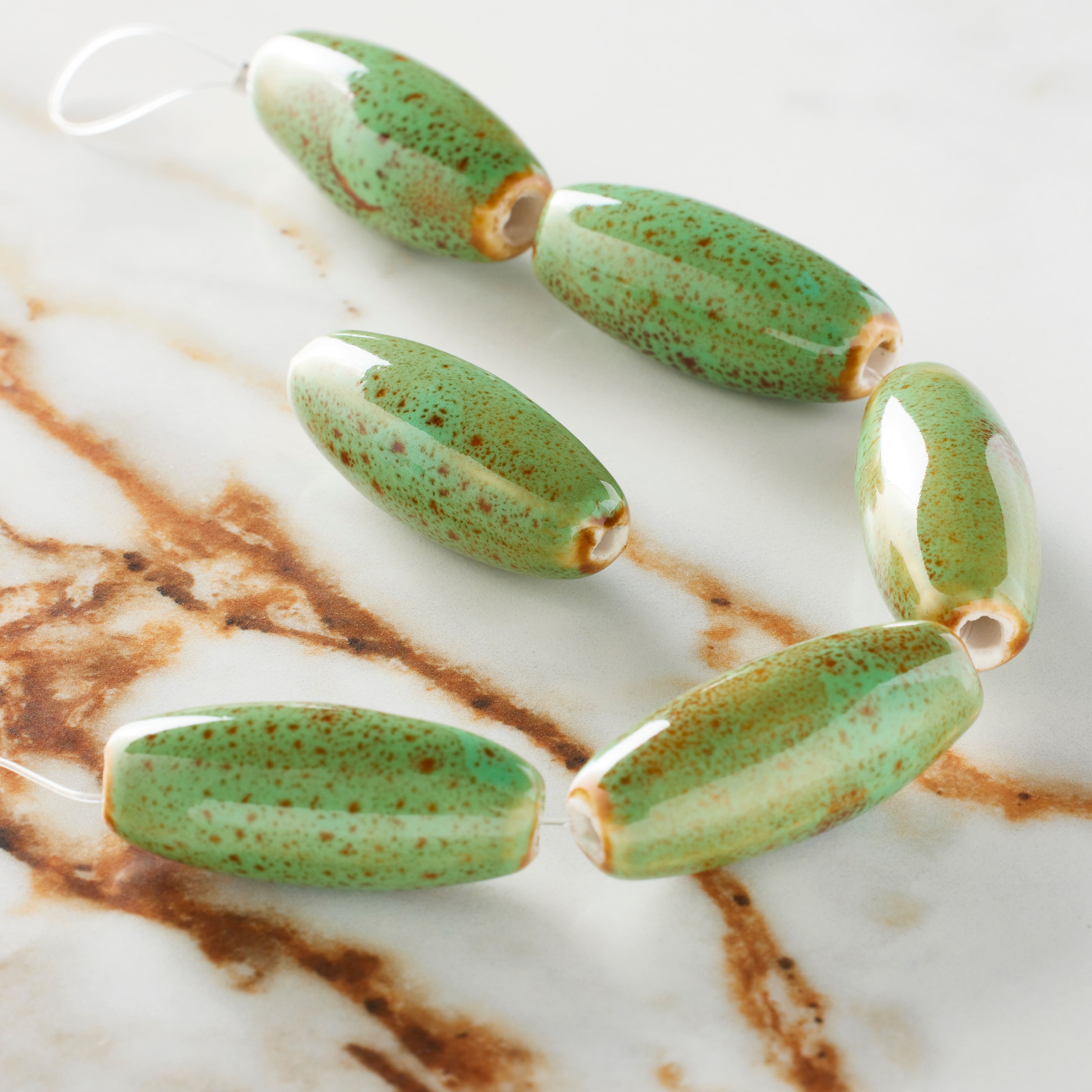 12 Packs: 6 ct. (72 total) Green Ceramic Oval Beads, 29.5mm by Bead Landing™