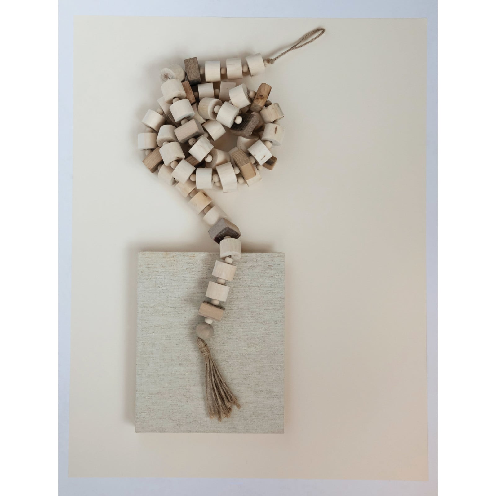 Hello Honey® 6ft. Natural Paulownia Wood Block Bead with Jute Tassels Garland