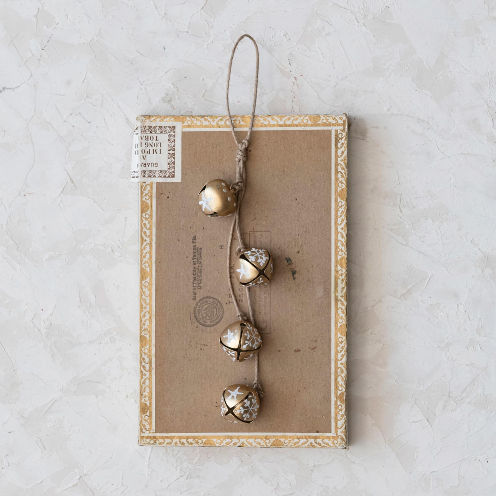 Hello Honey® 9" Hanging Metal Jingle Bells with Hand-Painted Stars & Snowflakes on Jute Rope Hanger