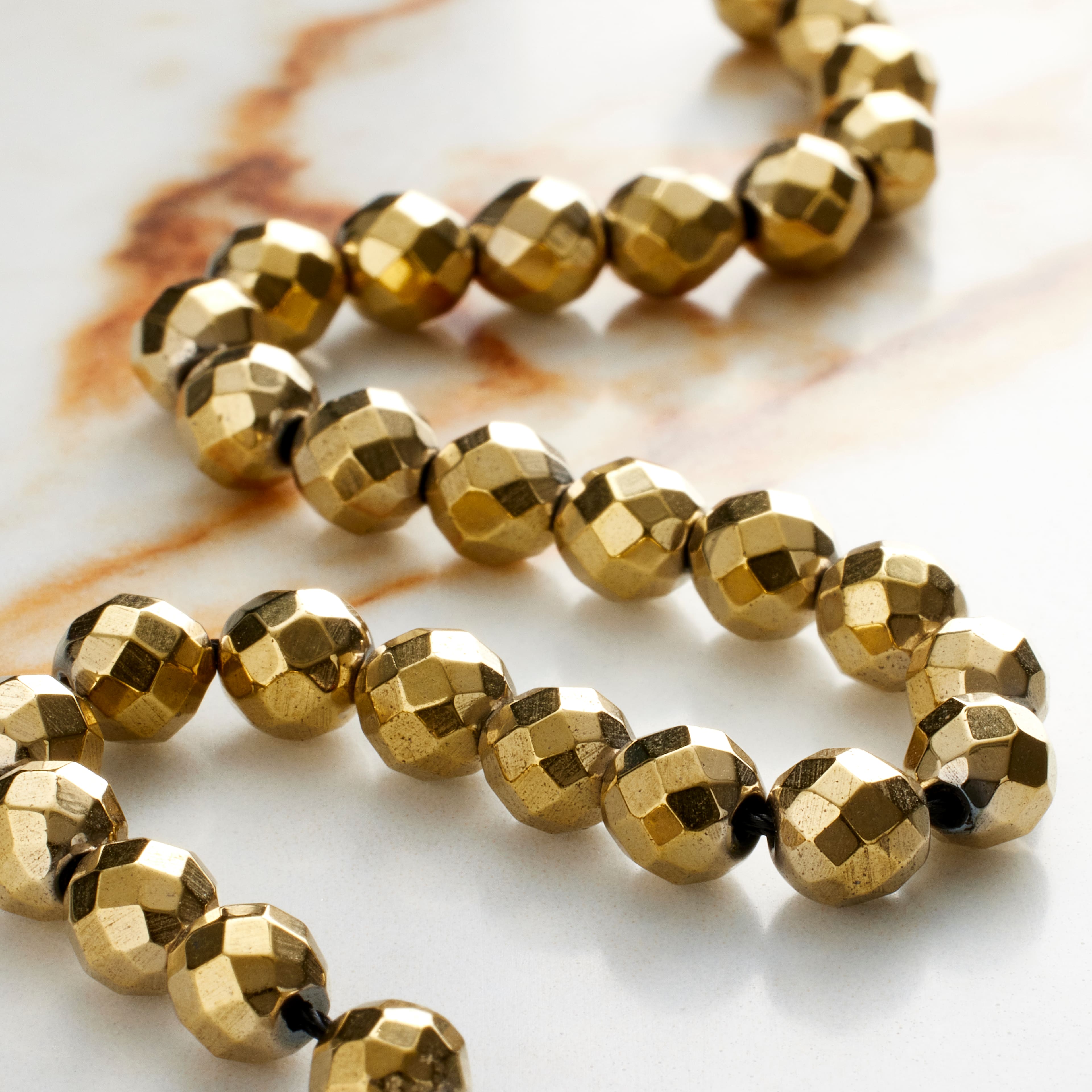 12 Pack: Gold Faceted Luster Hematite Round Beads, 6mm by Bead Landing™