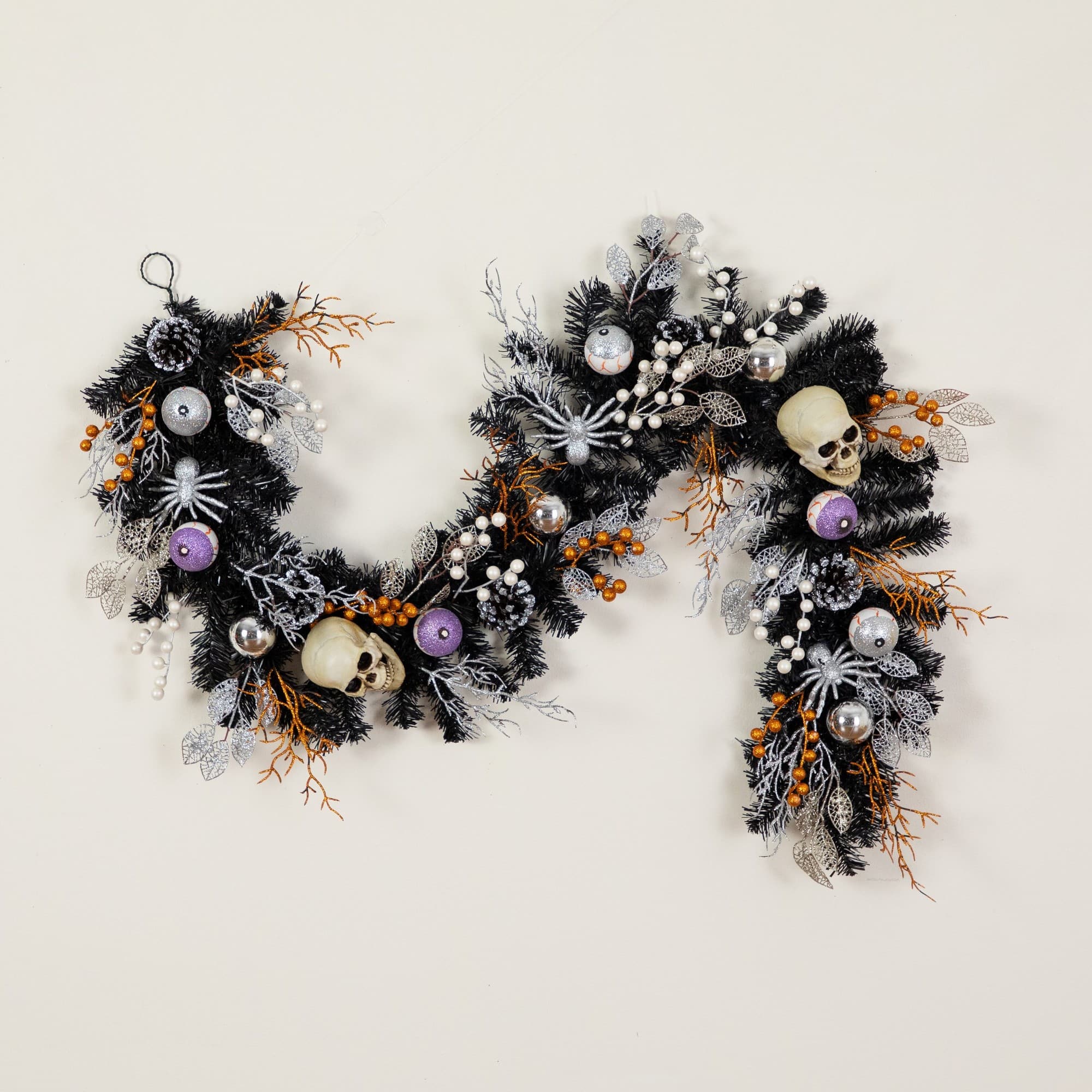6ft. Artificial Halloween Black Garland with Skulls, Eyeballs & Spiders
