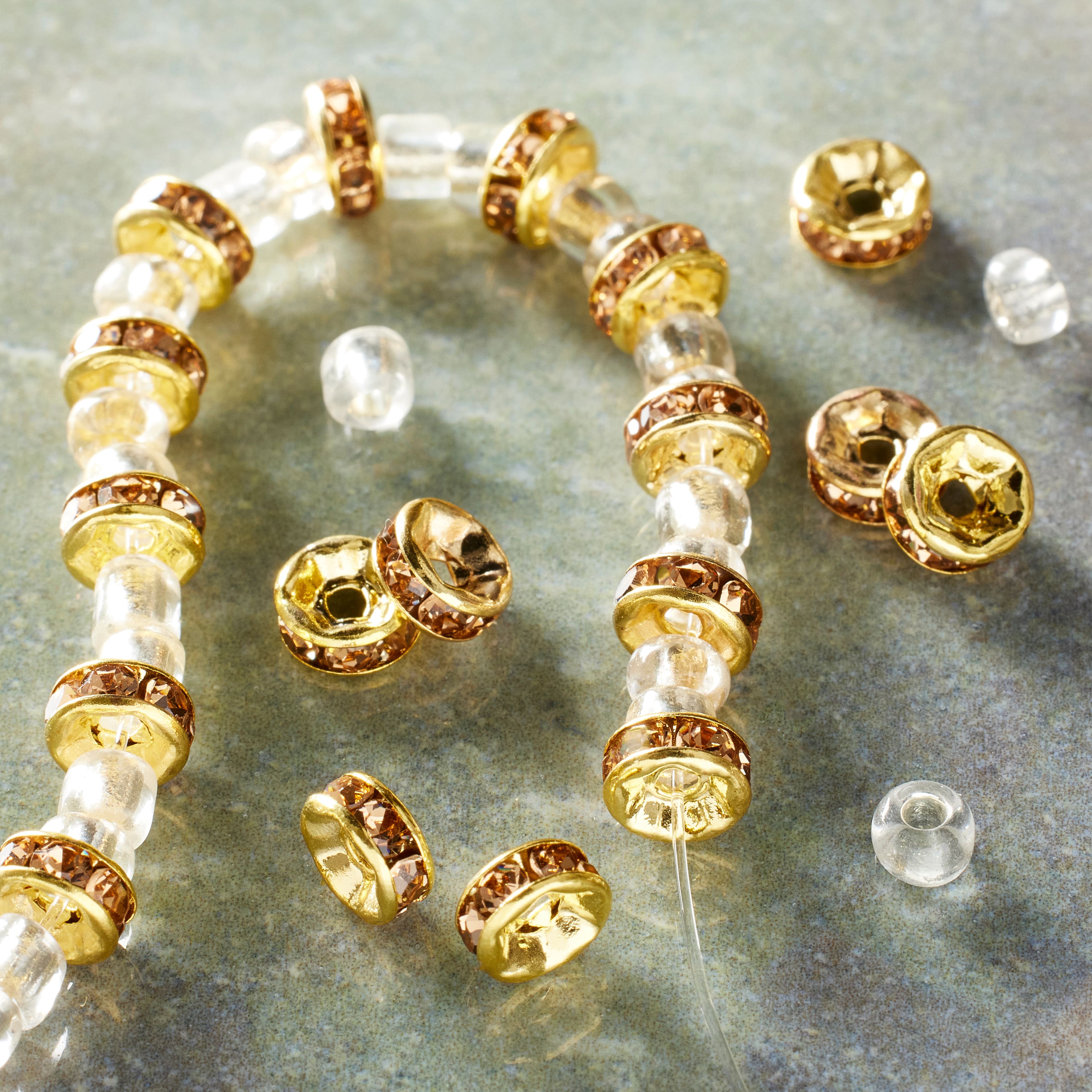 12 Pack: Amber Rhinestone Studded Rondel Beads, 6mm by Bead Landing™