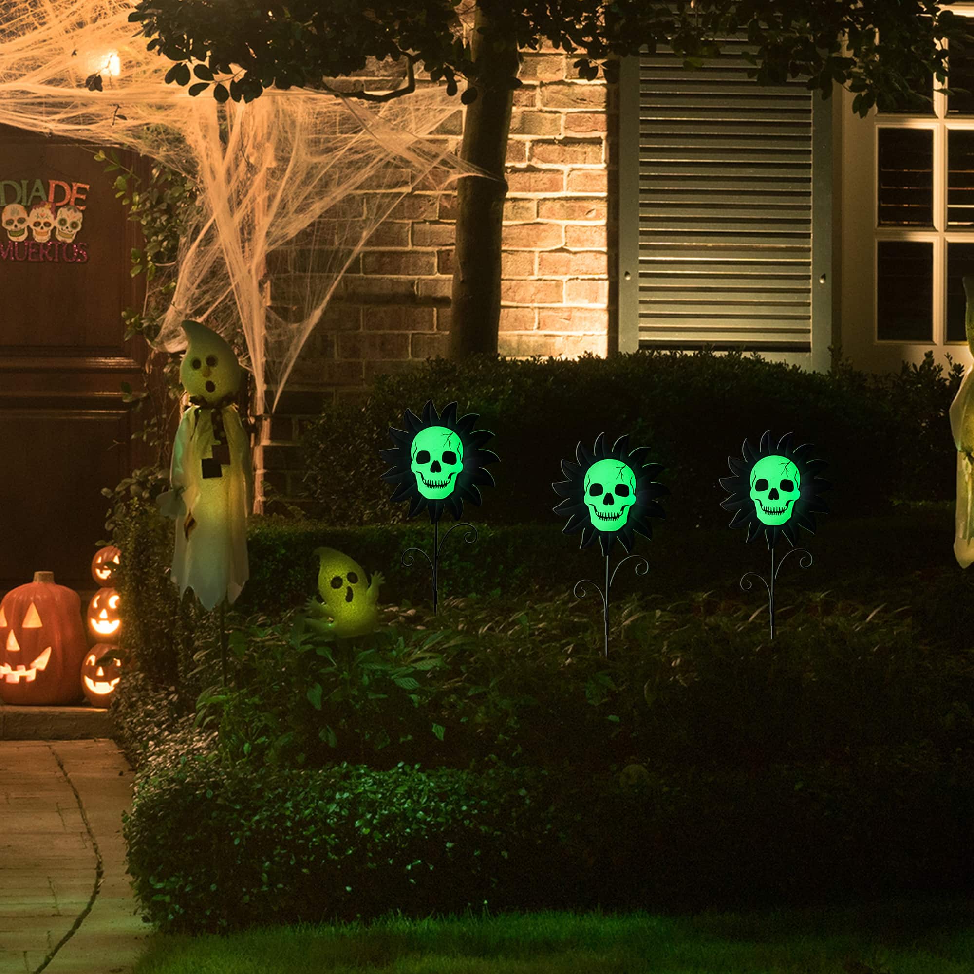 Glitzhome® 24" Halloween Metal Sunflower Skulls Glow-in-Dark Yard Stakes, 3ct.