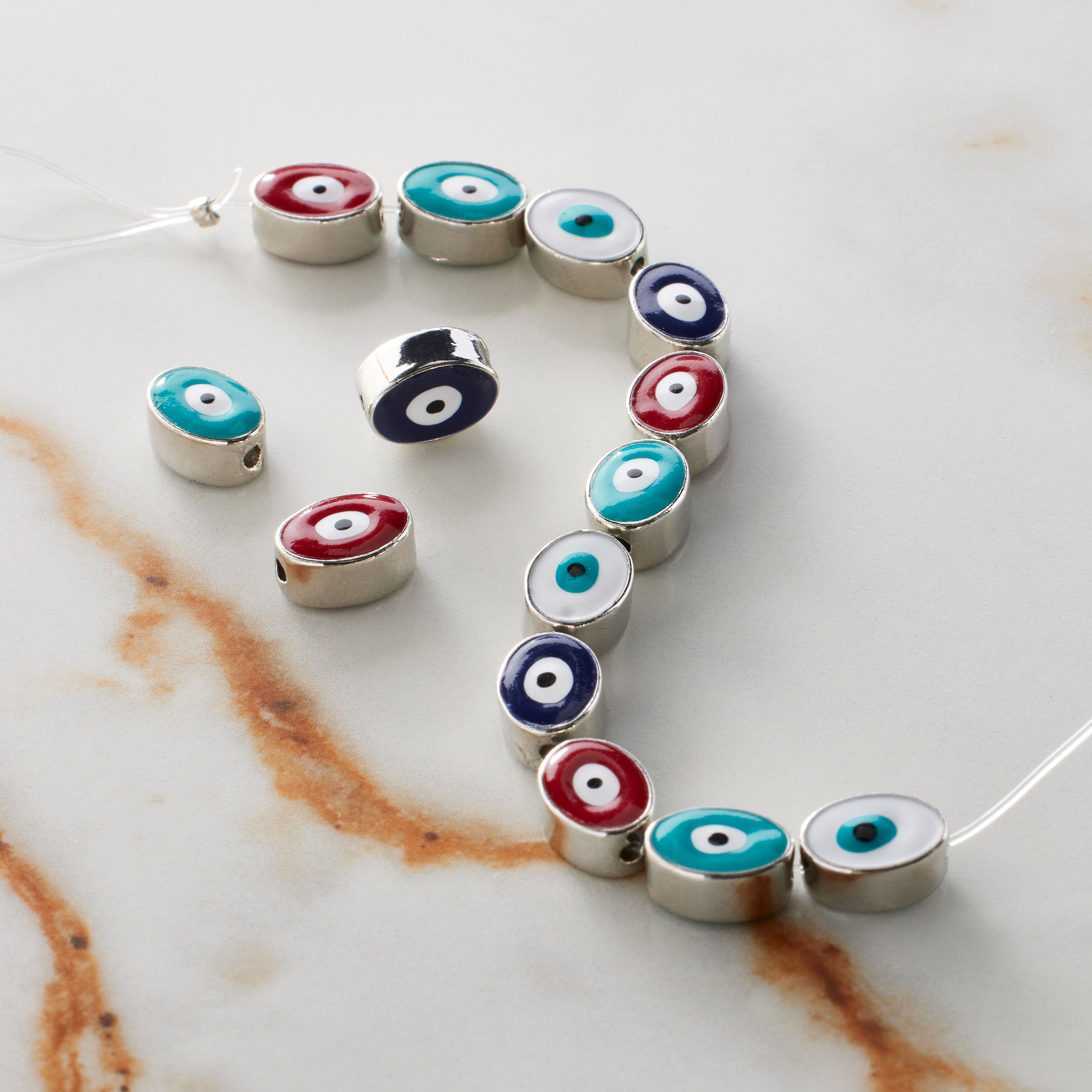 6 Packs: 14 ct. (84 total) Multicolor & Rhodium Evil Eye Oval Beads, 9mm by Bead Landing™