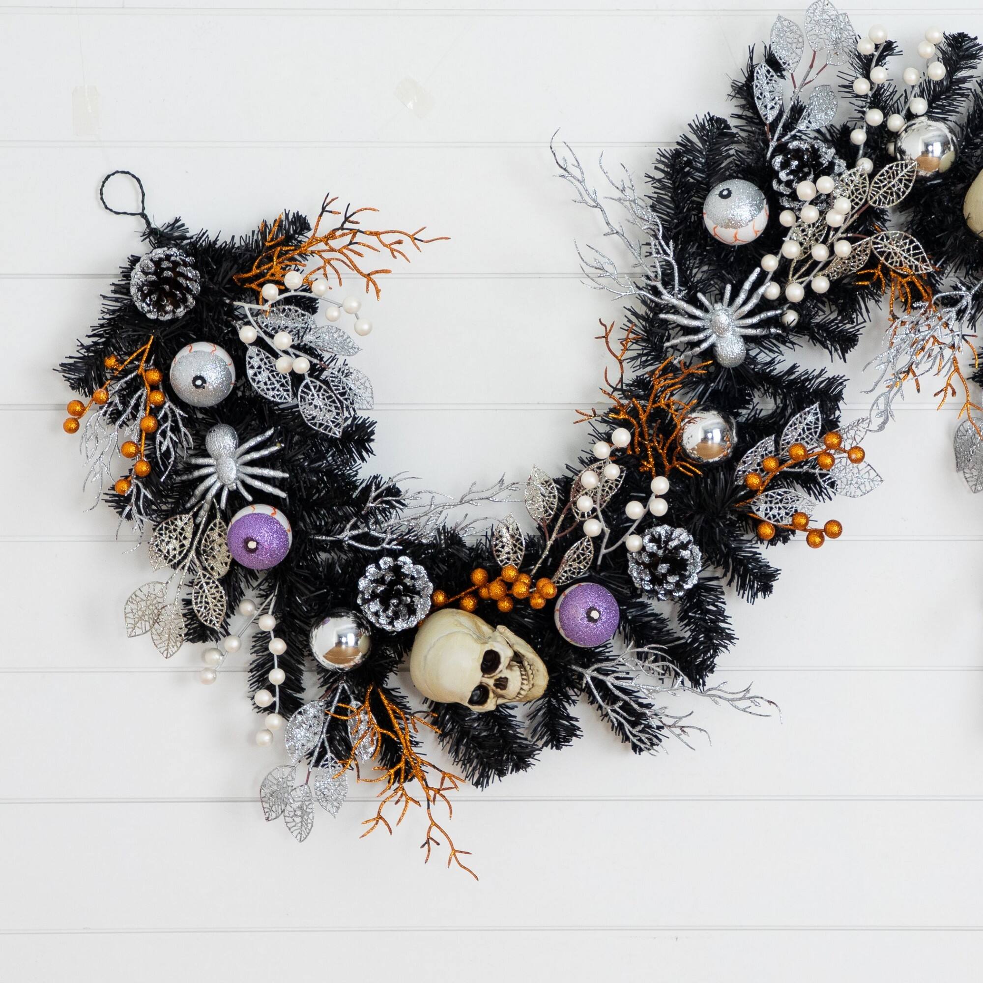 6ft. Artificial Halloween Black Garland with Skulls, Eyeballs & Spiders