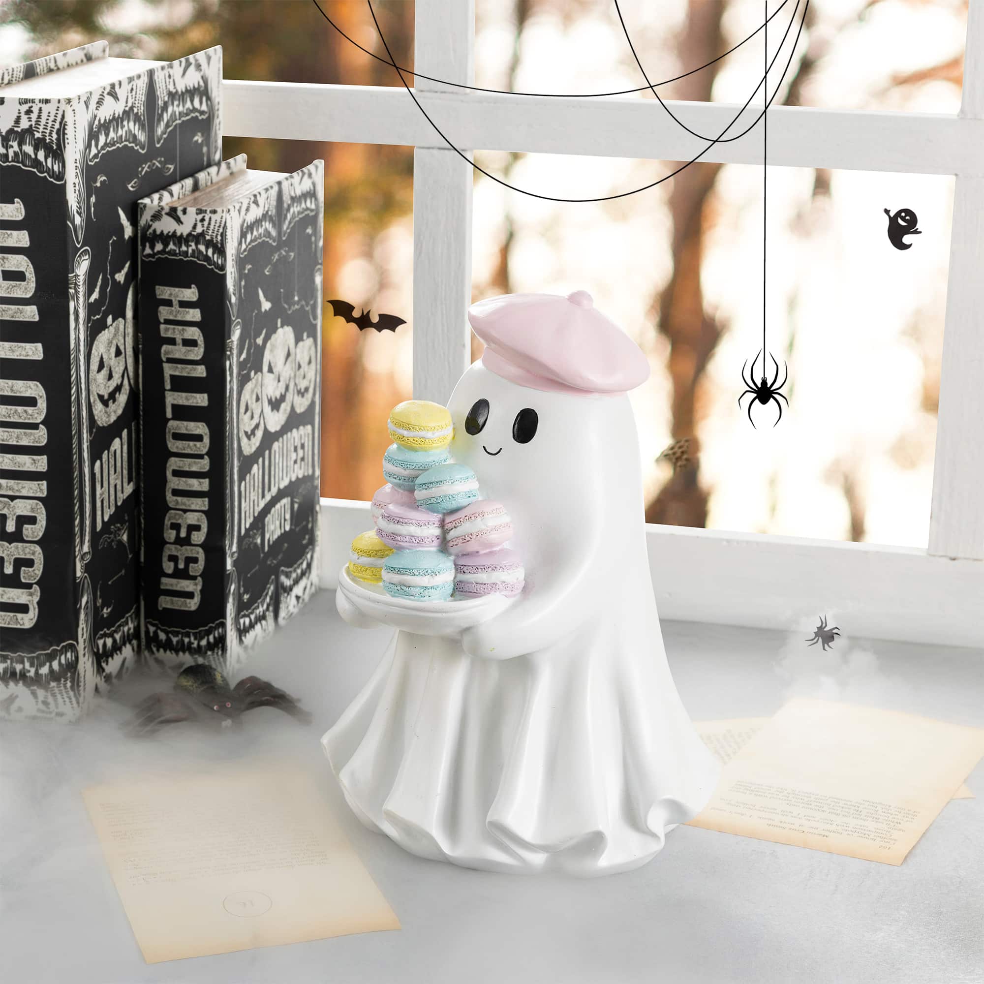 Glitzhome® 9.75" Halloween Polyresin Ghost with Macarons Table Decor