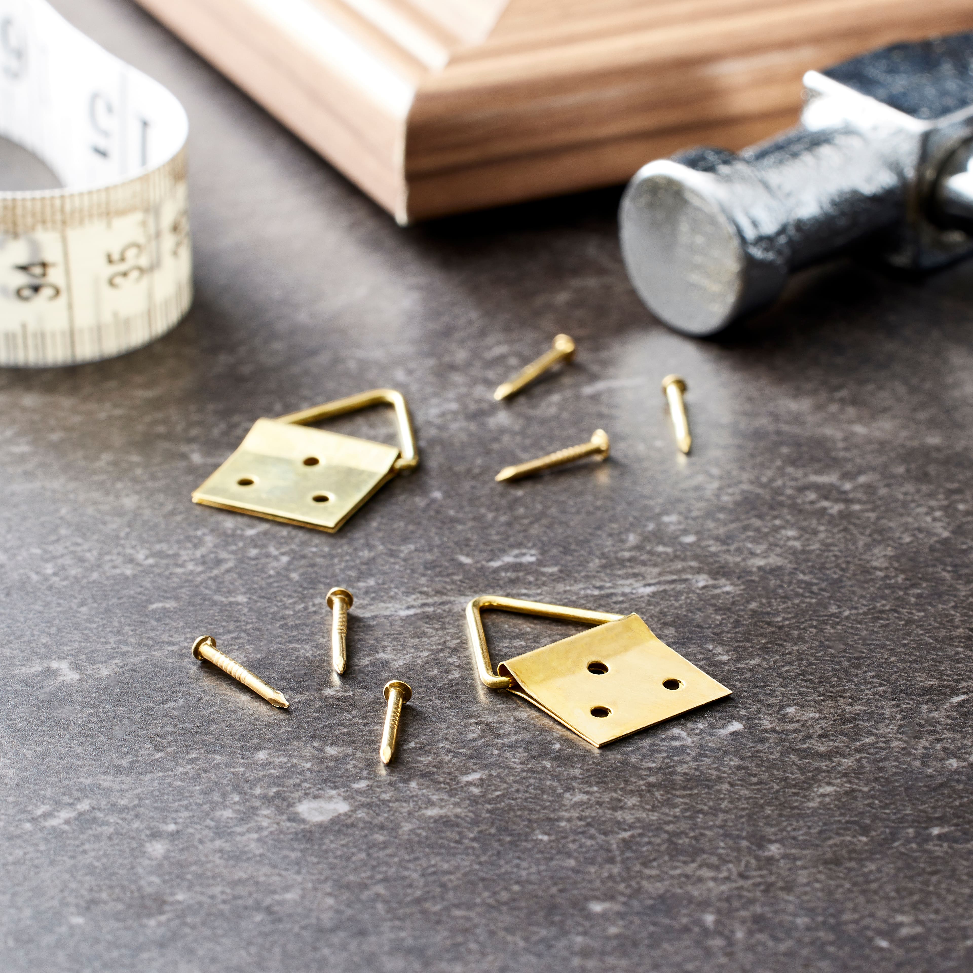 24 Packs: 2 ct. (48 total) Brass Triangle Ring Hanger by Studio Décor®