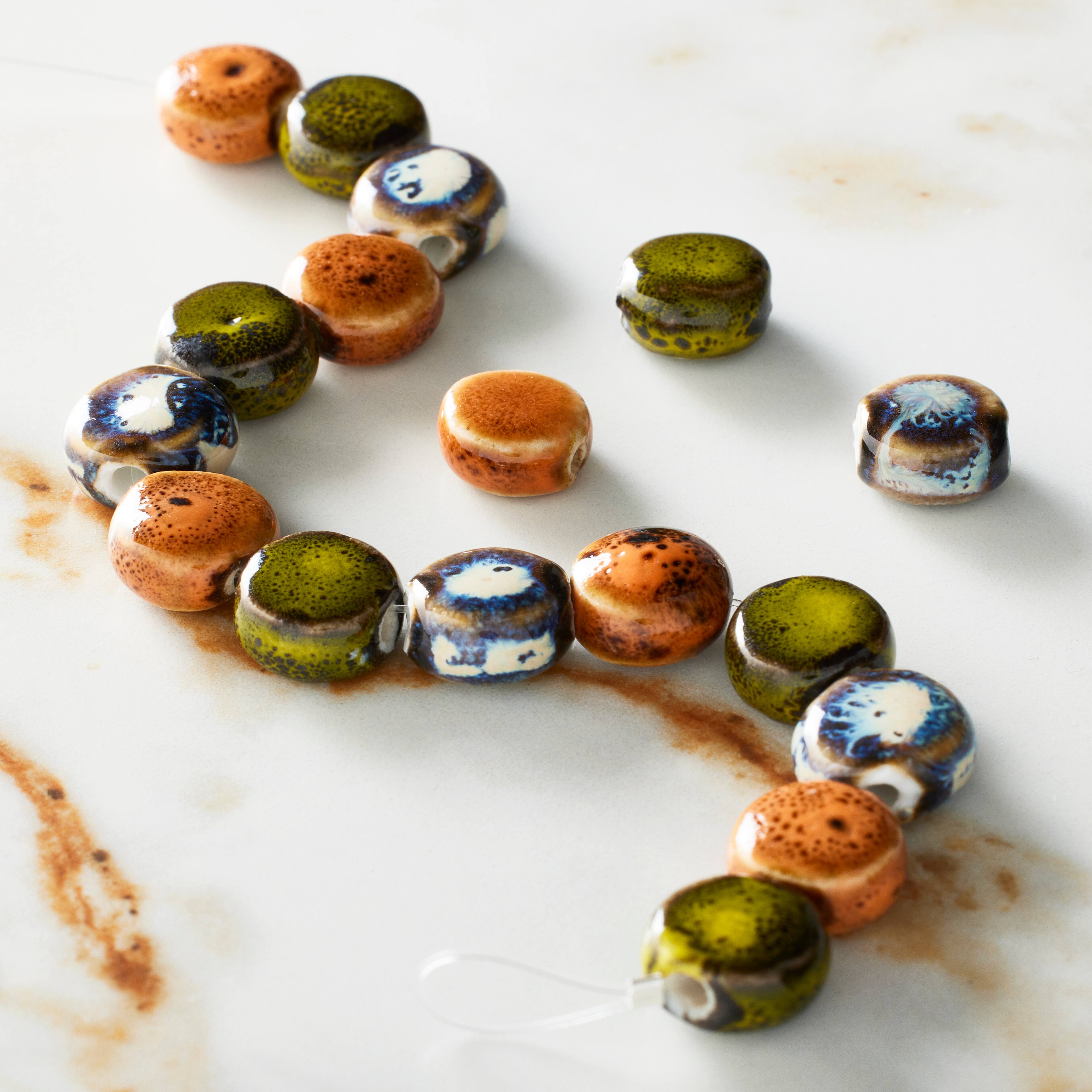 12 Packs: 17 ct. (204 total) Khaki, Orange & Blue Ceramic Coin Beads, 10.5mm by Bead Landing™