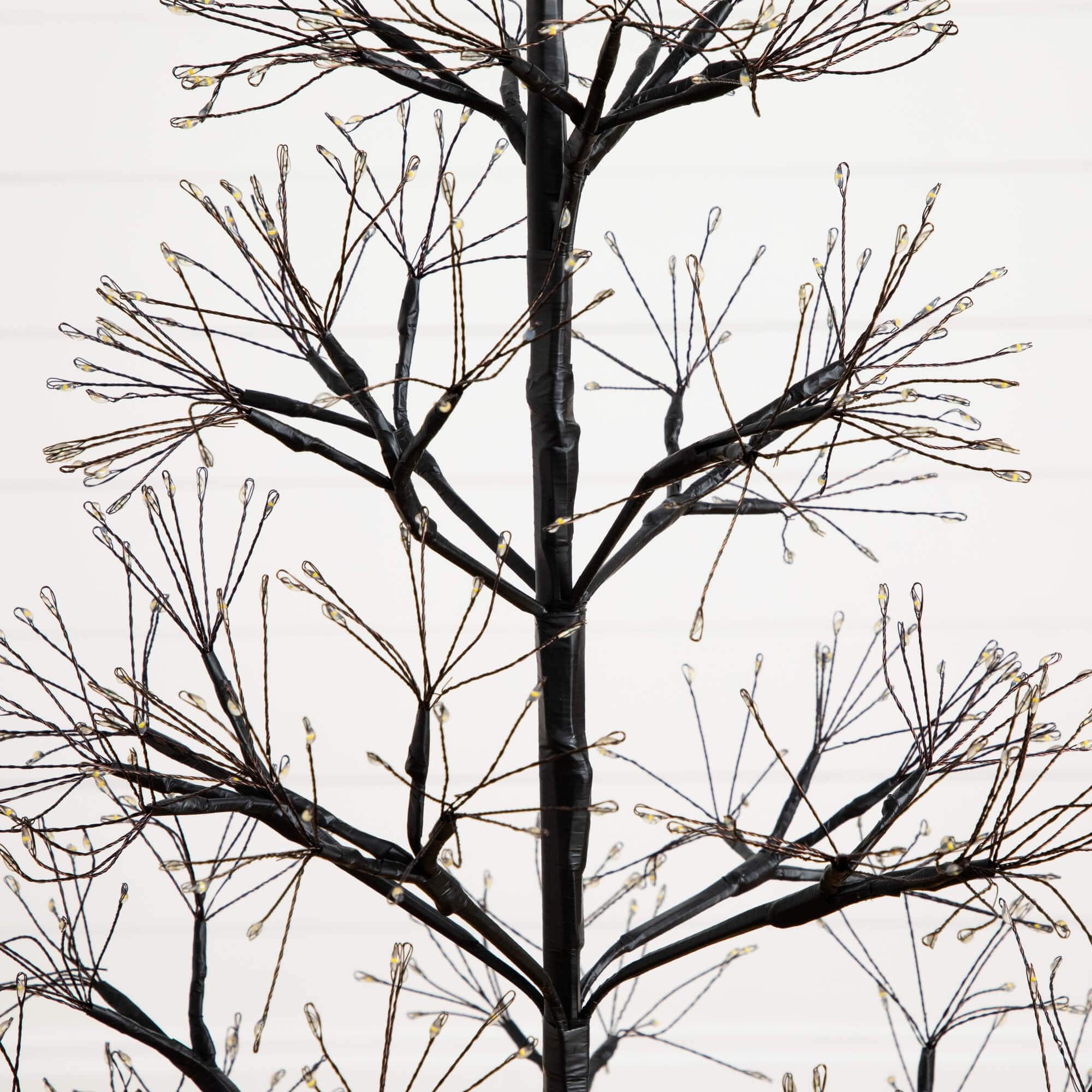 4ft. Pre-Lit Artificial Halloween Black Starburst Tree with 800 Fairy Warm White LED Lights