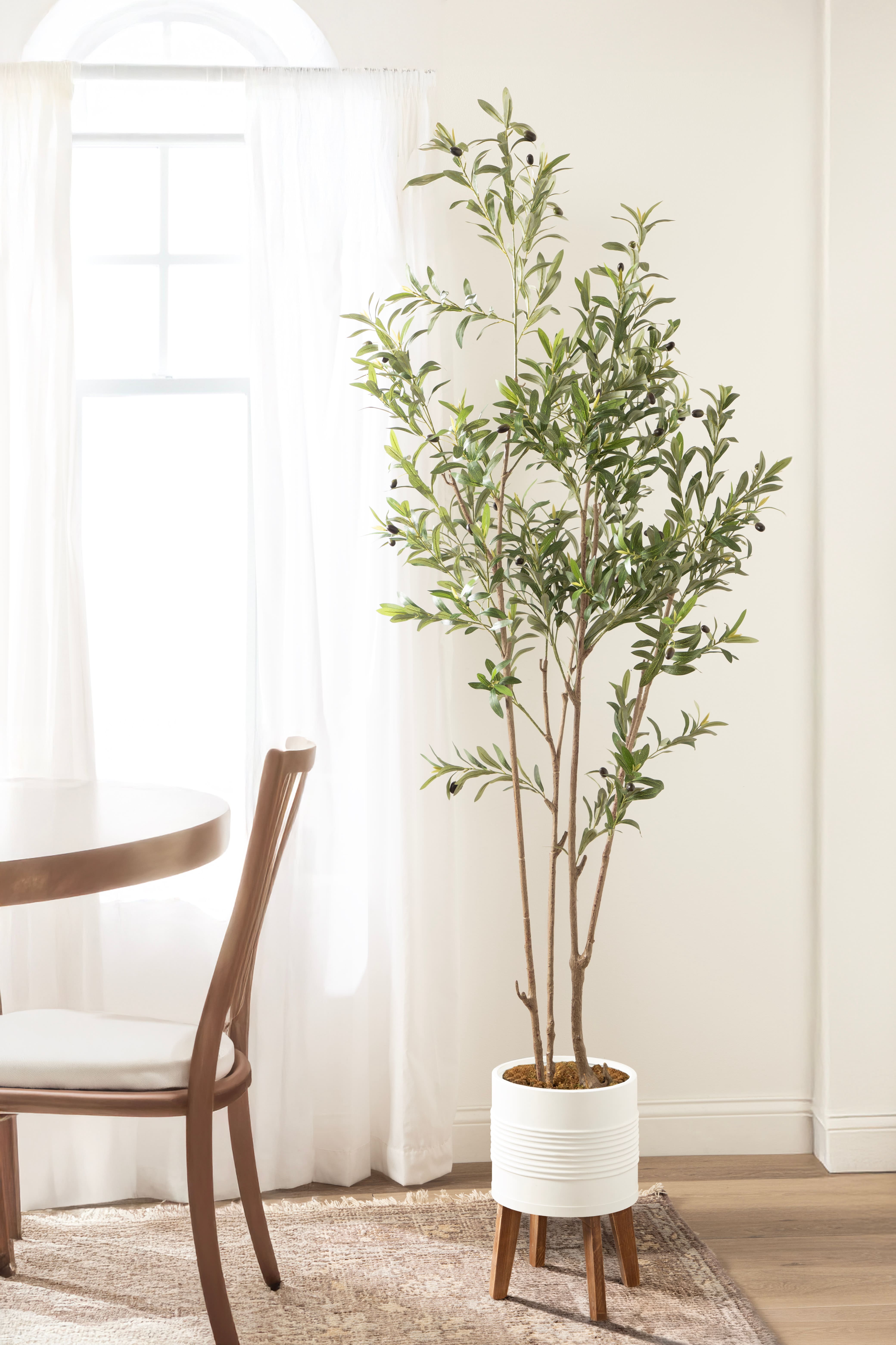 Kate and Laurel 7ft. Oliveira Faux Olive Tree in Rustic Brown Footed Planter